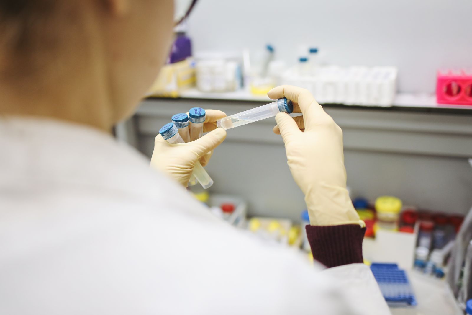 Scientist working at a microscope in a life-sciences lab